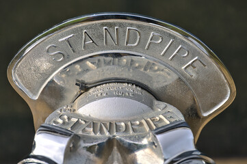 Beautiful closeup blurry view of silver standpipe head with inscription, Dublin, Ireland. Soft and selective focus