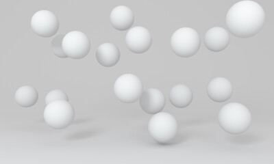 White floating spheres on photography studio background.