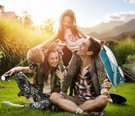 Foto op Canvas Cheerful family realxing on a camp © konradbak