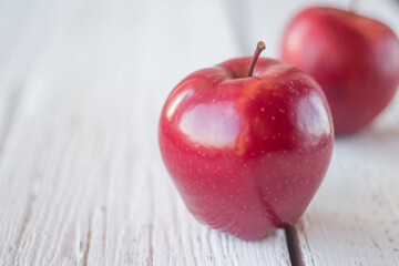 Empty space for text. Big red apple on white boards.