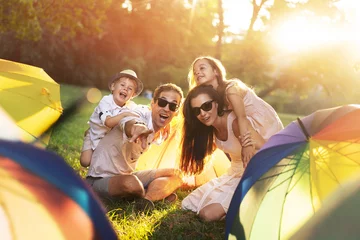 Foto op Canvas Cheerful family enjotying summer weather in the park © konradbak