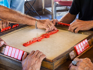 Puerto Rico Close-up of Hands of Men Playing Red Dominoes