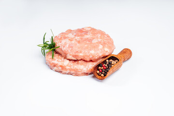 Fast food for home and restaurants. Semi-finished product, chicken meat fast cooking. Copy space.Chicken burgers on a white plate with black pepper and a rosemary branch.