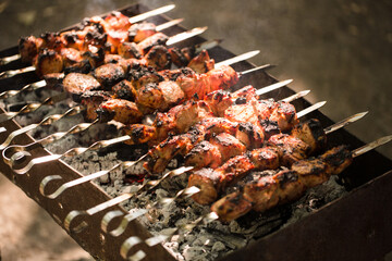 Marinated shashlik preparing on a barbecue grill over charcoal. Shashlik or Shish kebab popular in Eastern Europe. Shashlyk (skewered meat) was originally made of lamb. Roast Beef Kebabs On BBQ Grill.