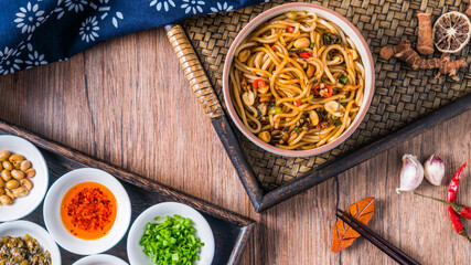 A bowl of Jiangxi Nanchang cuisine Nanchang mixed noodles placed on a wooden table 