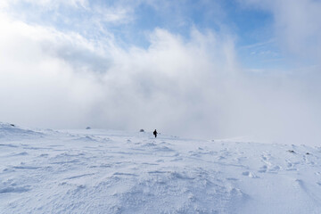 Man walking alone on a snowy mountain