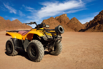 single yellow quad bike in egyptian desert