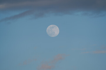Big Moon with some clouds and blue sky at the afternoon