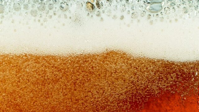 Super Slow Motion Detail Shot of Rippling Beer Bubbles