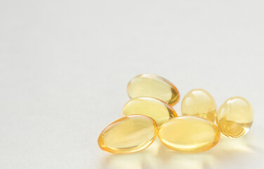 Fish oil pills on white background. Macro photo