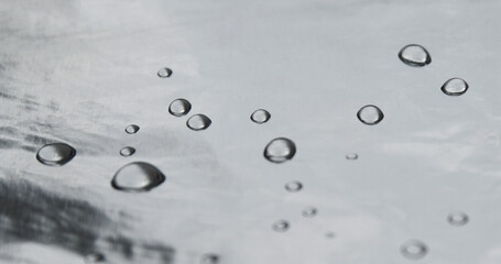 Water drops on silver foil. Macro photo