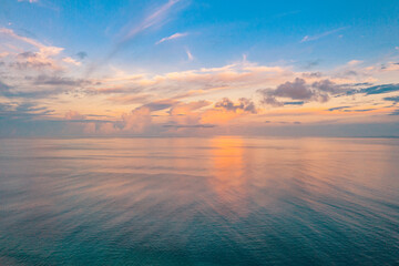 Fototapeta na wymiar Relaxing seascape with wide horizon of the sky and the sea. Sunset over the sea, tranquil nature view, aerial ocean panorama. Colorful clouds, sunrise sunset dream natural environment, Earth concept