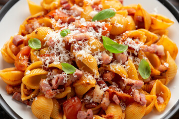 Conchiglie alla Amatriciana pasta with pancetta bacon, tomatoes and pecorino cheese. Healthy Italian food
