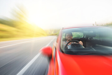 Obraz na płótnie Canvas Man with a beard driving a car.