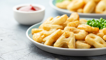 Alphabet potato fries snack with green peas and ketchup on plate. party food © grinchh
