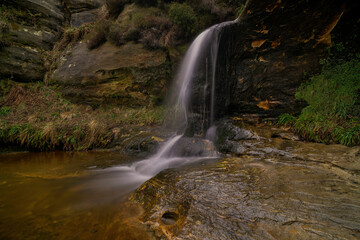 close up of the john knox waterfall in the lomond hills, fife, scotland.
