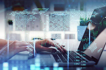 Businesswoman hands with laptop, world map and graph changes
