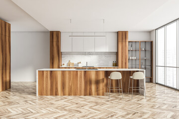 White and wooden kitchen interior with table and chairs, parquet floor