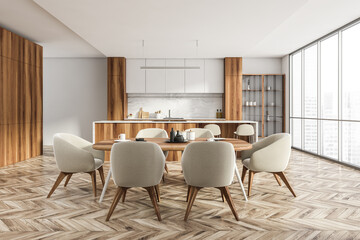 White wooden kitchen interior with eating table and chairs, city view