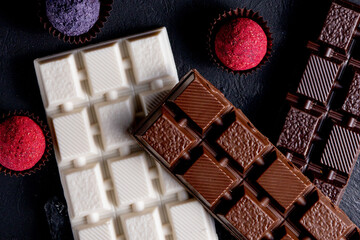 Chocolates background. Chocolate. Assortment of fine chocolates in white, dark, and milk chocolate. Praline Chocolate sweets