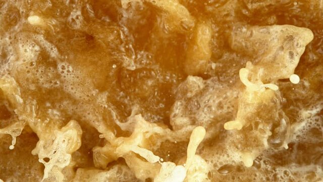 Super Slow Motion Detail Shot of Rippling Beer