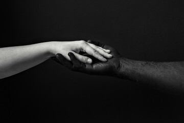Black male and white female hands, open palms to each other. A symbol of the struggle for black...