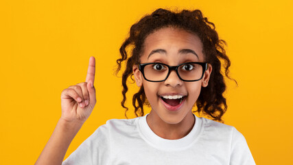 Excited black girl has great idea and points up