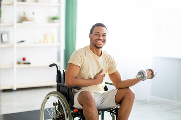 Physical rehabilitation for disabled people. Handicapped black guy in wheelchair making exerises...