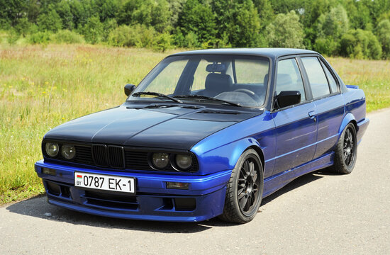 MINSK BELARUS-02.07.2012:Blue car BMW E30 324d on the road in the country.