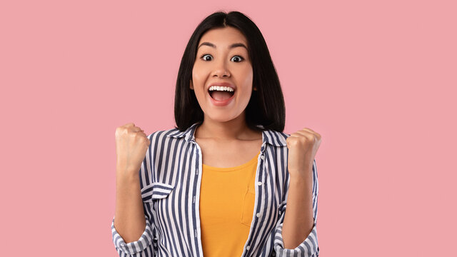 Yes. Portrait Of Emotional Asian Woman Screaming With Raised Fists