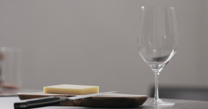 vintage cheese on oliveboard with wine glass
