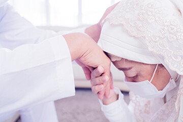 Old woman in face mask apologizing to her husband