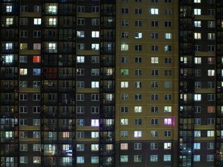 Fototapeta na wymiar blinking windows of the building at night