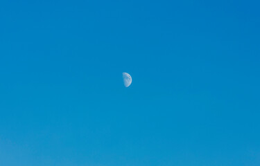 Beautiful view of moon at sunset on blue sky.  Beautiful summer nature backgrounds. Sweden.