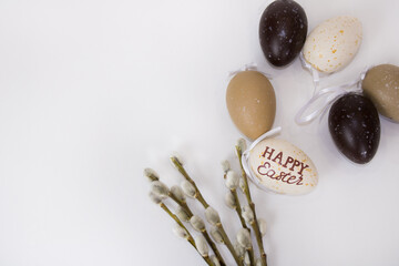 Willow twigs and Easter eggs are on a white isolated background. Background for Happy Easter. There is a place for your text.