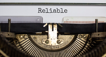 Reliable symbol. The word 'reliable' typed on retro typewriter. Business, reliable concept. Beautiful white background.