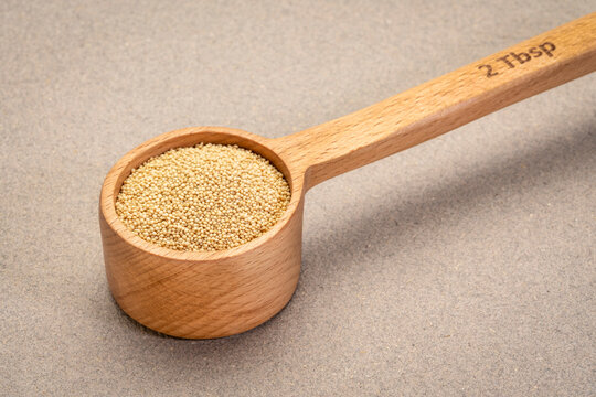 gluten free amaranth grain in wooden measuring scoop (2 tablespoons), healthy eating concept