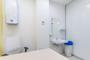 Fototapeta na wymiar Doctor's office with wall mounted UV bactericidal air sterilizer and washbasin
