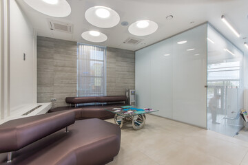 Spacious waiting room in a modern clinic. Waiting area with seats in hospital