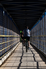 Boys crossing the footbridge on the BR 242 in Luis Eduardo Magalhães by bicycle.