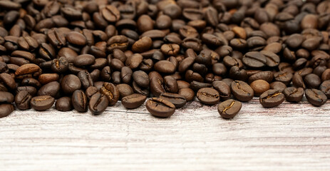 Coffee beans on wood background	
