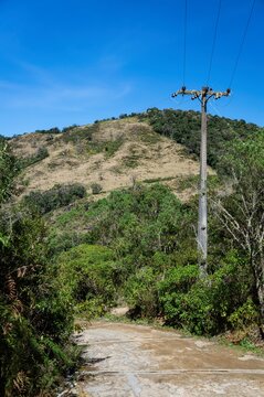 An electric pole at the side of steep rough path that leads to Pedra da Macela viewing spots.