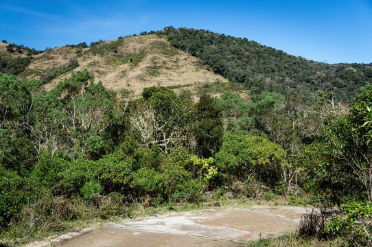 Mountainous landscape covered with fresh green vegetation saw from the hiking trail that leads to Pedra da Macela view spots.