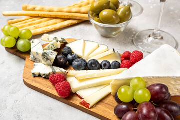 Cheese board set Italian or French cheeses parmesan, pecorino, gorgonzola cheese and berries,...