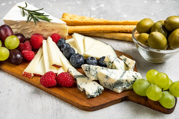 Cheese board set Italian or French cheeses parmesan, pecorino, gorgonzola cheese and berries,...