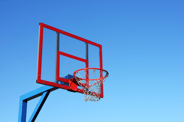 Basketball hoop on clear blue sky.