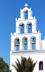 White Bell Tower of orthodox church of Panagia Platsani, in the village of Oia. Santorini. Greece