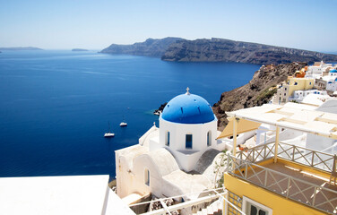 Oia village,Santorini. With blue Church domes and white washed houses on the Island of Santorini, Greece.