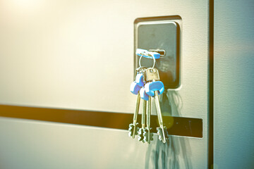 Keys stuck in a lock. closeup Door lock keys, Real estate concept door handle, Key insert and hold...