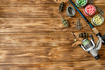 Accessories for carp fishing and fishing baits on wooden planks with copy space